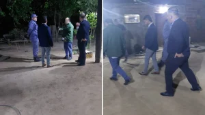 Efectivos policiales y otras personas reunidas en un patio durante la noche.